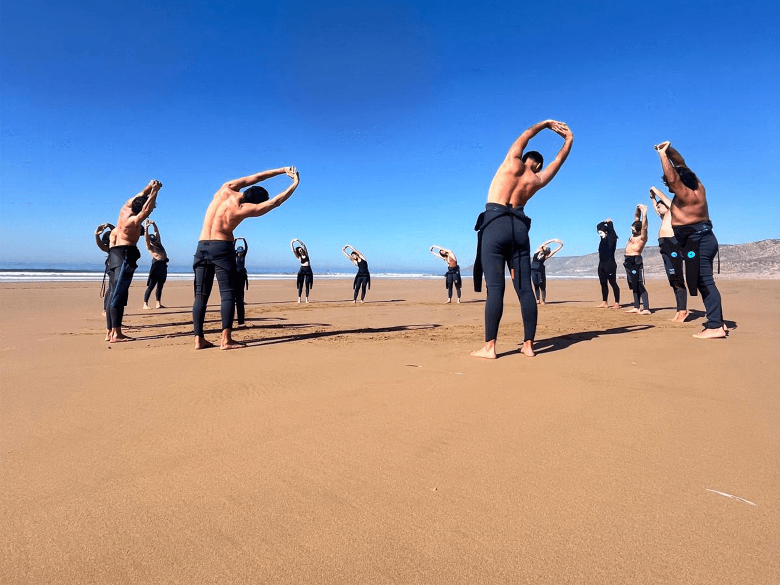 Team beach workout at sunrise building flow and innovation